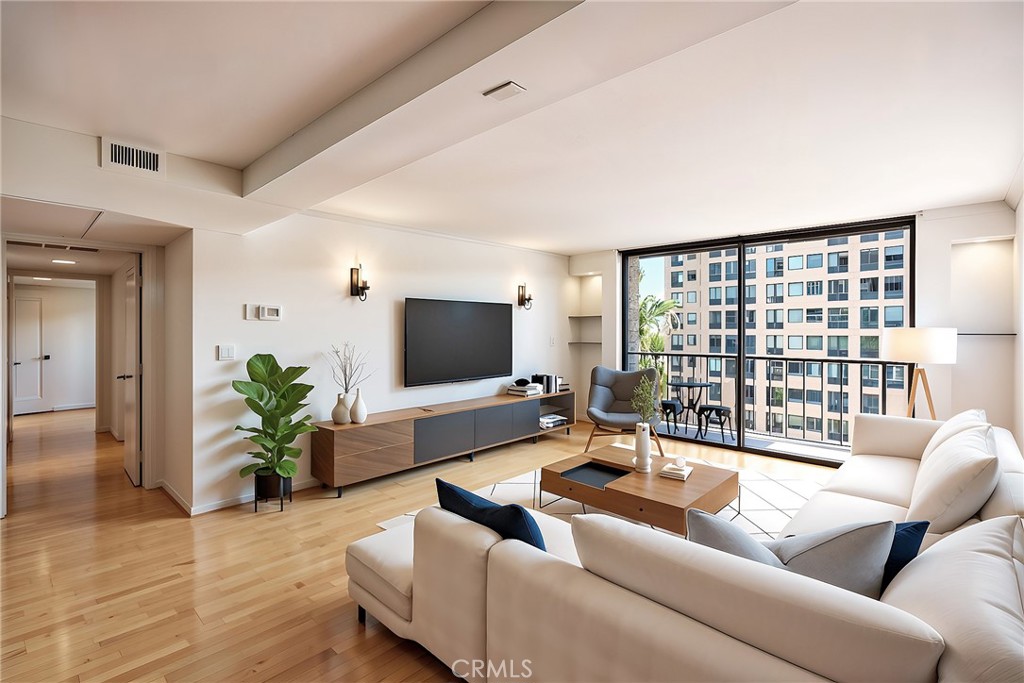 10535 Wilshire Boulevard, Unit 912 Los Angeles, CA 90024 - Photo 5 of 33 a living room with furniture and a flat screen tv