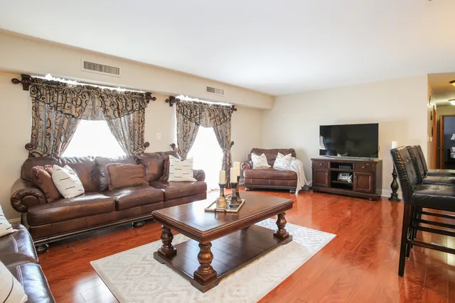 a kitchen with stainless steel appliances kitchen island granite countertop a stove a sink and a refrigerator