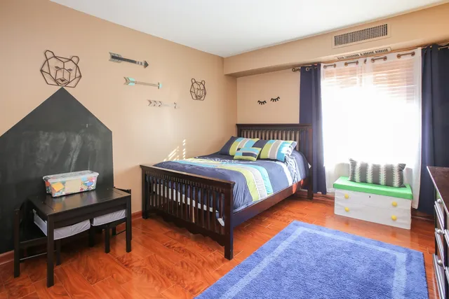 a bathroom with a granite countertop sink toilet mirror and shower