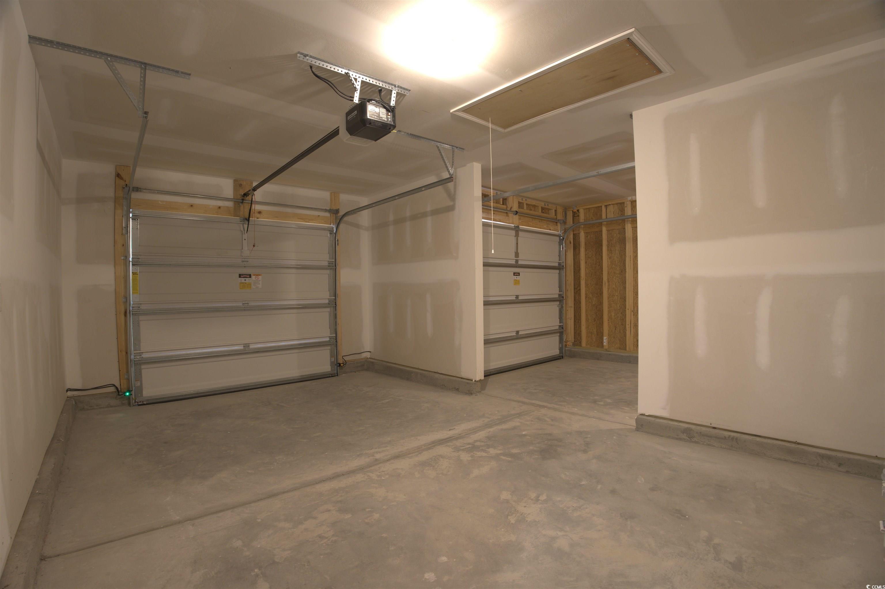 217 Kc Lane Aynor, SC 29511 - Photo 2 of 14 Garage featuring a garage door opener