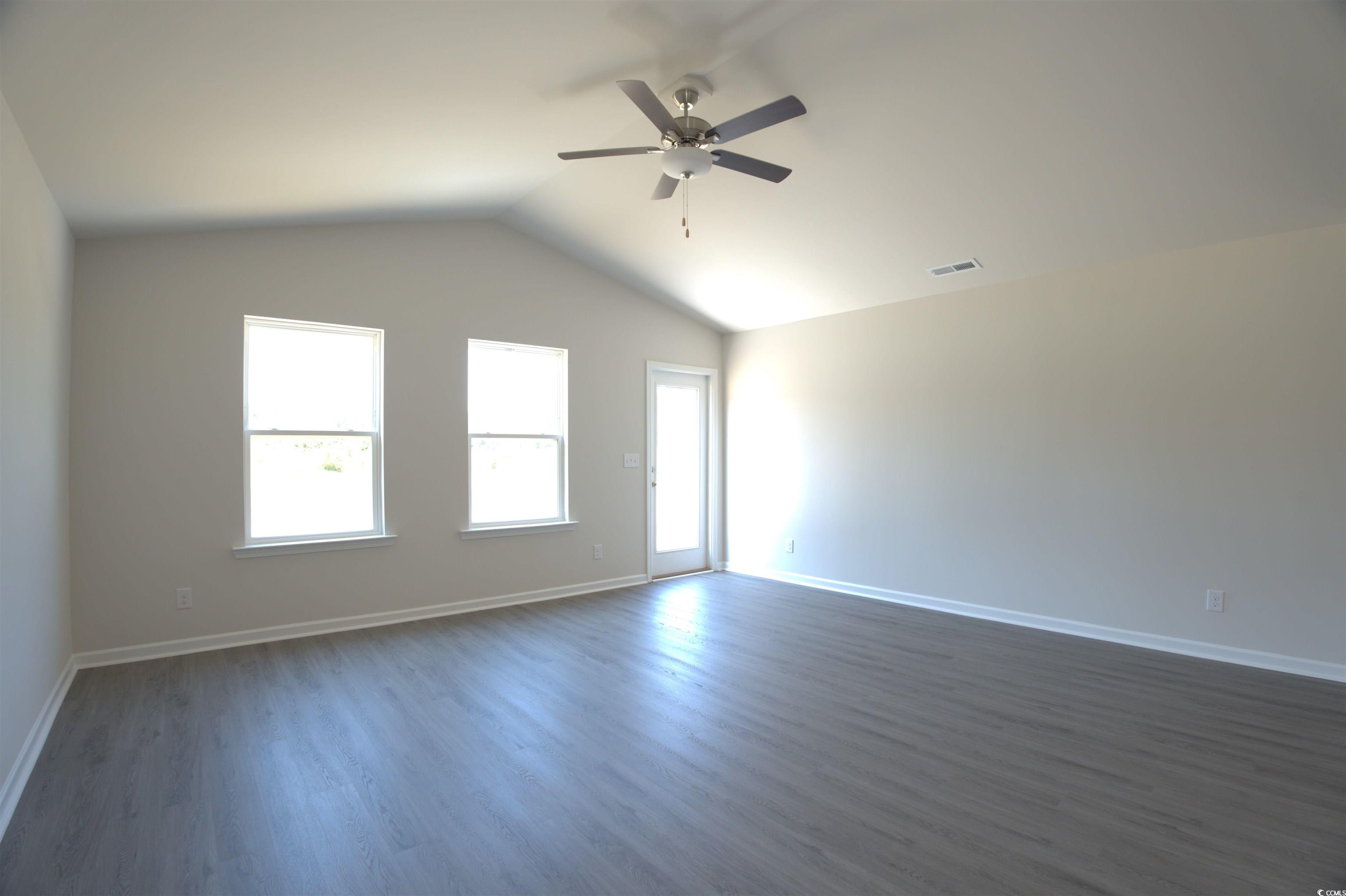 217 Kc Lane Aynor, SC 29511 - Photo 7 of 14 Unfurnished living room featuring lofted ceiling, healthy amount of natural light, and dark wood finished floors