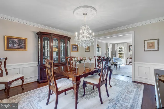 a view of a dining room with furniture and chandelier