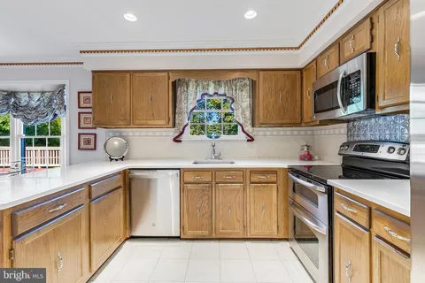 a kitchen that has a sink and a stove in it