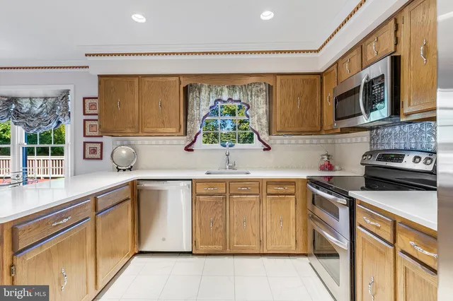 a kitchen that has a sink and a stove in it