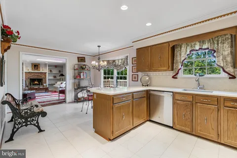 a kitchen with stainless steel appliances granite countertop sink stove and refrigerator