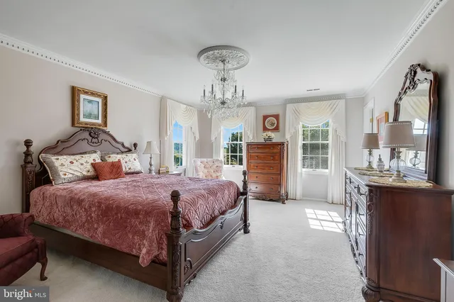 a bedroom with a bed and dresser with mirror