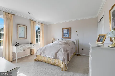 a spacious bedroom with a bed and a couch