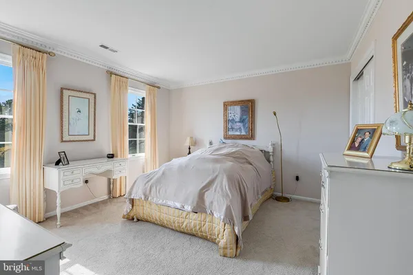 a spacious bedroom with a bed and a couch