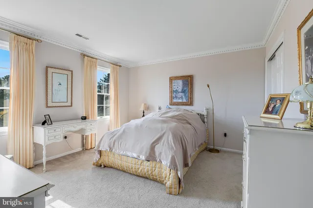 a spacious bedroom with a bed and a couch