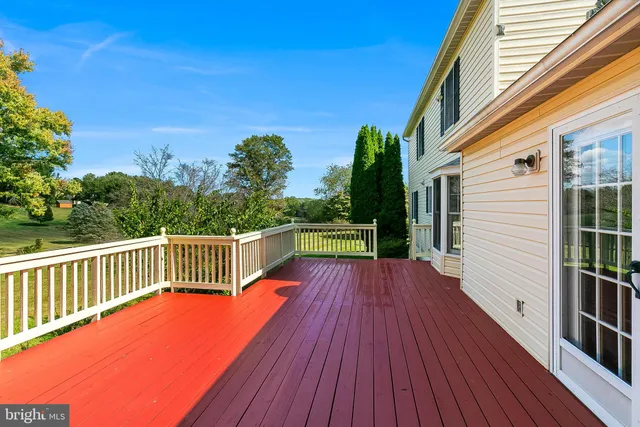a view of balcony with wooden floor and fence