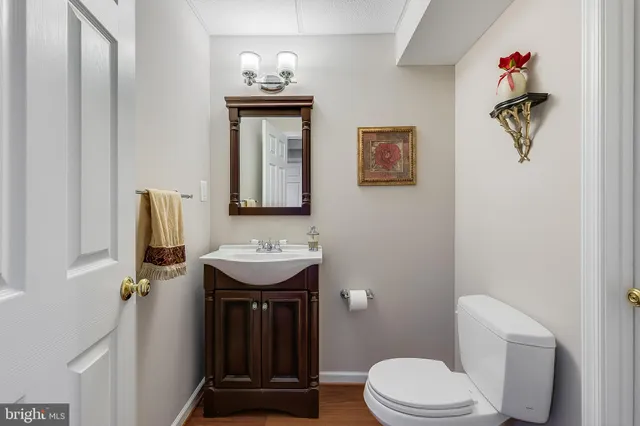 a bathroom with a sink mirror vanity and toilet