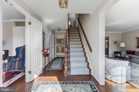 a view of entryway and hall with wooden floor