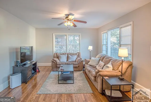 a living room with furniture and a flat screen tv