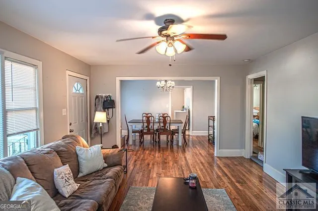 a living room with furniture dining table and a flat screen tv