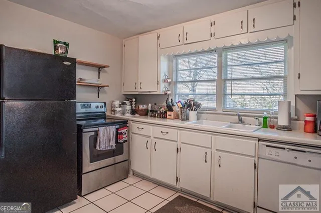 a kitchen with appliances a sink and cabinets