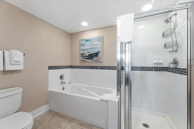 a bedroom with a large bed a chandelier and closet