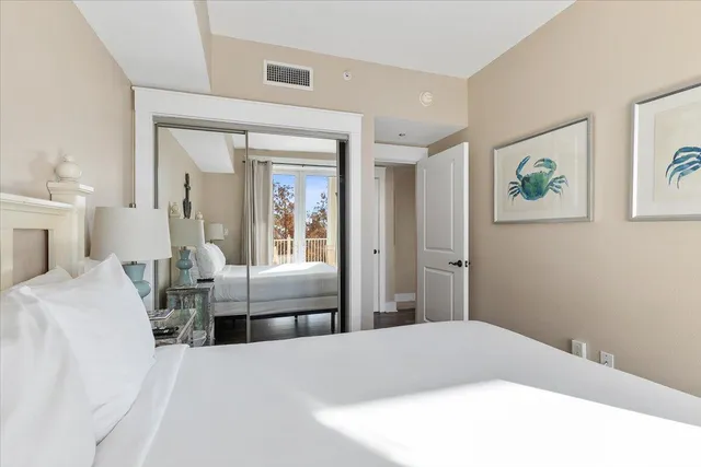 a balcony with wooden floor table and chairs