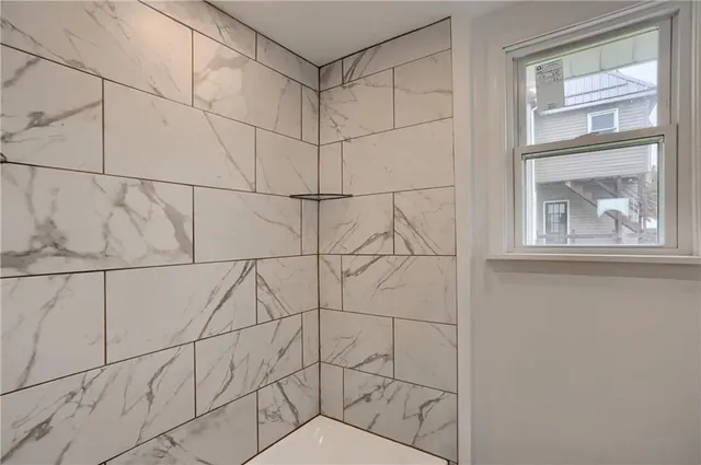 a bathroom with a window and a shower