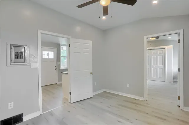 an empty room with closet and a chandelier fan