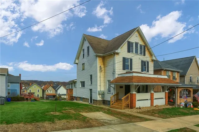 a front view of a house with garden