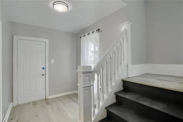 a view of entryway and hall with wooden floor