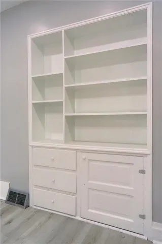 a view of walk in closet with empty racks