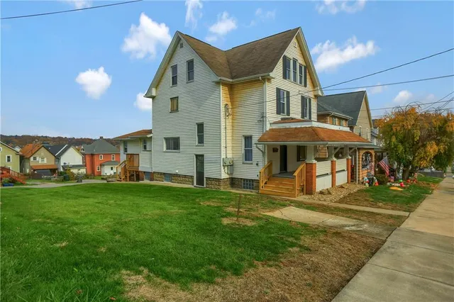 a front view of a house with a yard
