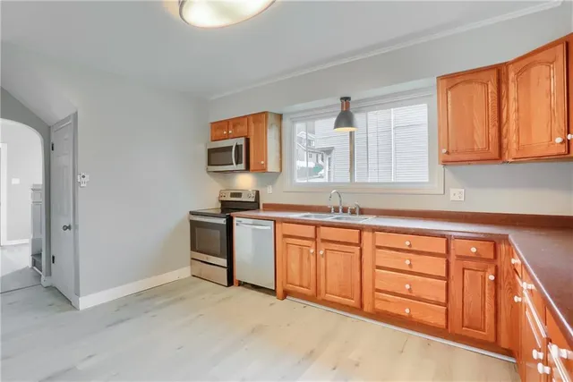 a kitchen with stainless steel appliances granite countertop a stove and a sink