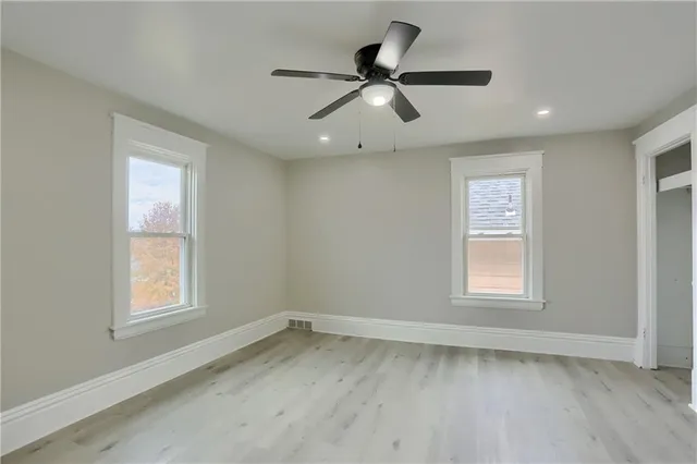 a view of a livingroom with a ceiling fan and window