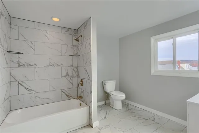 a bathroom with a bathtub and a toilet