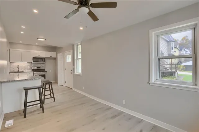 a view of kitchen with windows and furniture