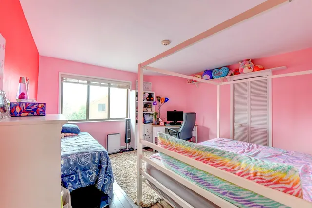 a bedroom with furniture and flat screen tv