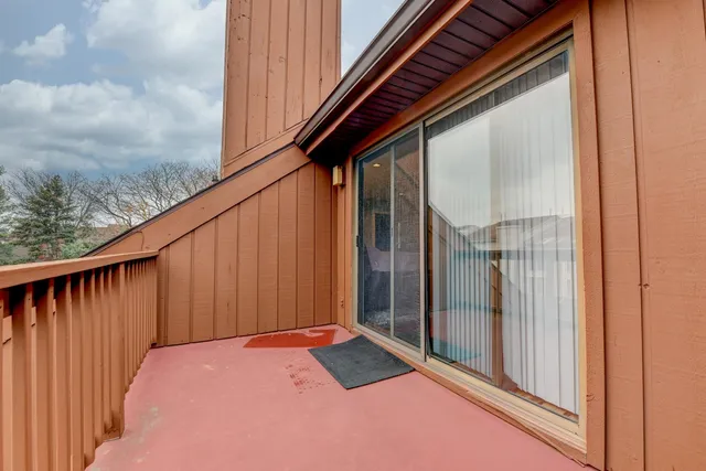 a balcony with wooden floor in city view