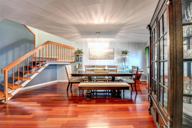 a dining room with furniture wooden floor and a chandelier