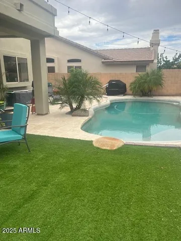 a view of a house with a backyard and a patio
