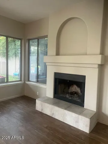 a living room with a fireplace with wooden floor