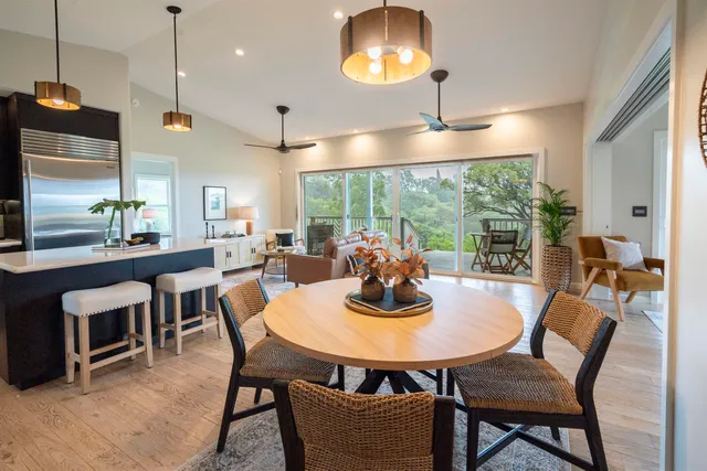 a dining room with furniture a chandelier and wooden floor