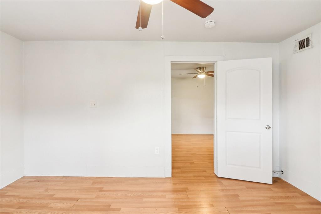 1906 Grainger Street Fort Worth, TX 76110 - Photo 27 of 38 Empty room featuring wood-type flooring
