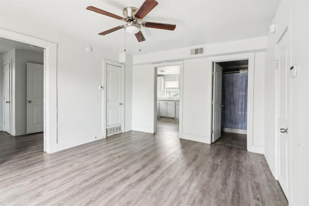 1906 Grainger Street Fort Worth, TX 76110 - Photo 3 of 38 wooden floor in an empty room with a window