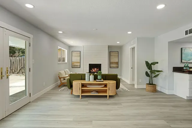 a living room with furniture and a fireplace