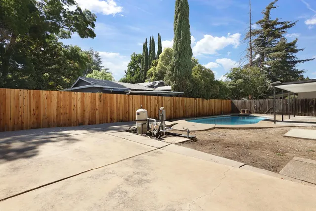 a view of a swimming pool with lounge chairs