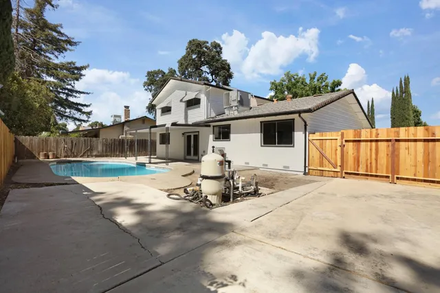 an aerial view of a house with a swimming pool and outdoor space