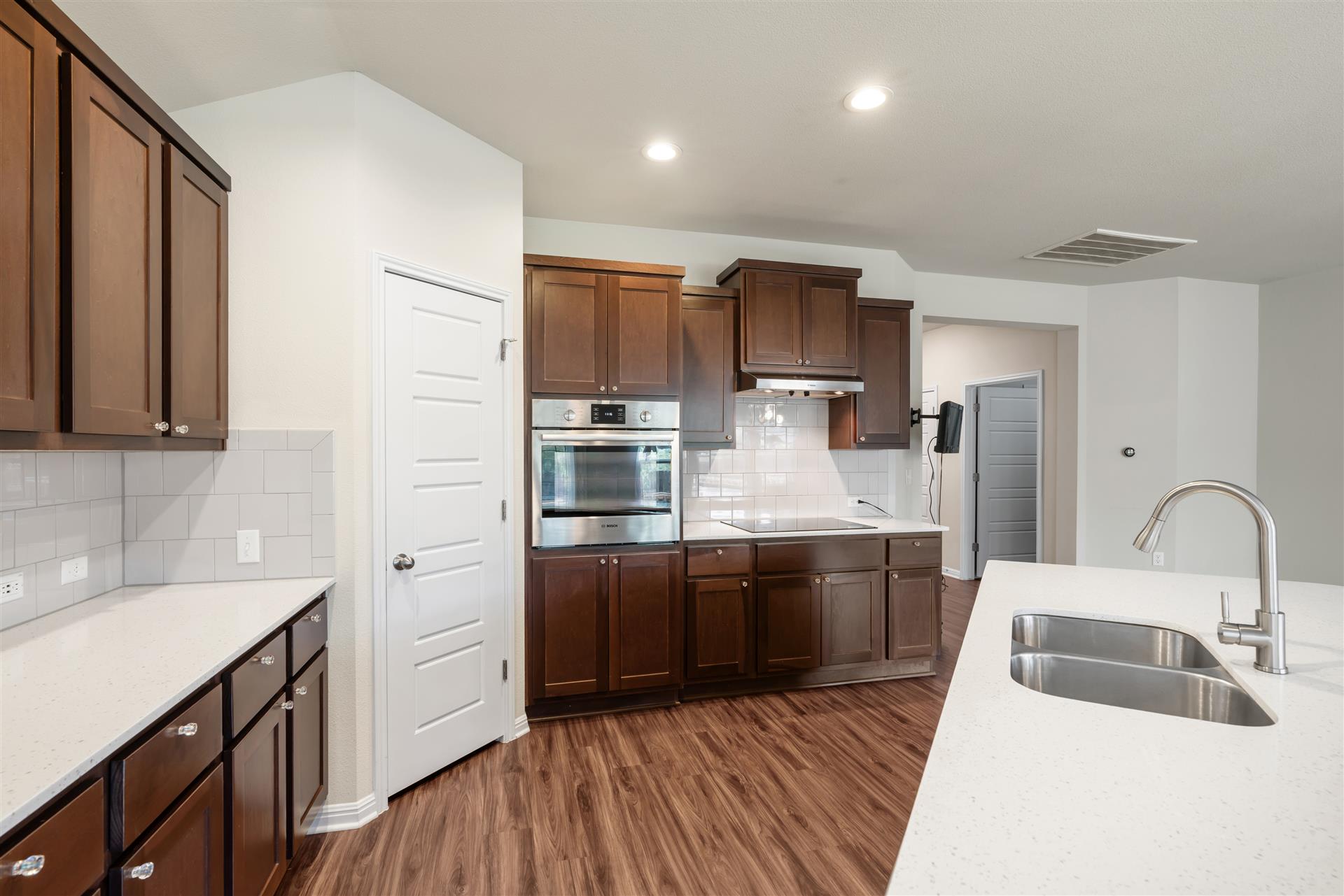16512 Enamorado Road Manor, TX 78653 - Photo 22 of 31 Culinary aspirations come alive in this kitchen, featuring sleek stainless steel appliances and abundant cabinetry.