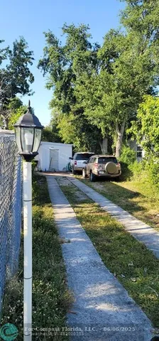 a view of a yard with wooden fence