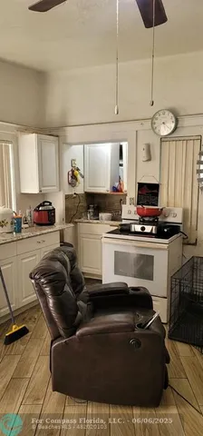 a kitchen with appliances a sink and cabinets