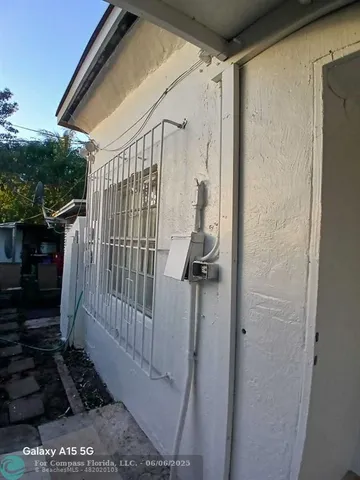 a view of a house with wooden floor and bench