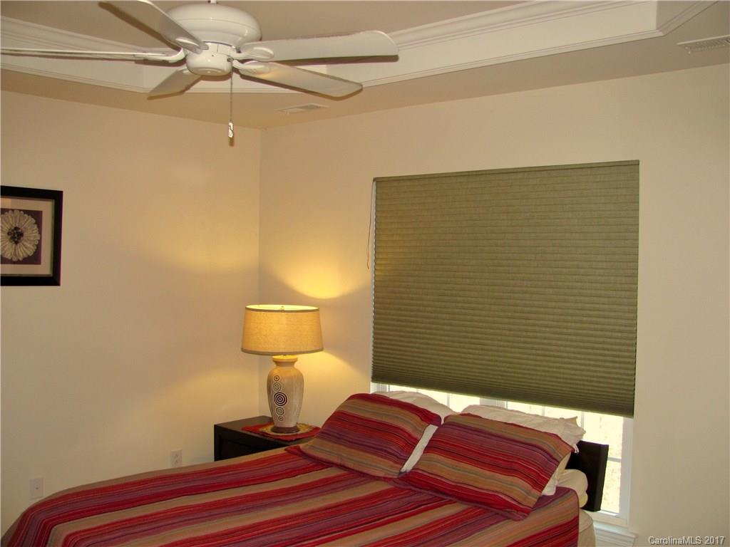 1068 Drayton Court, Unit 100 Fort Mill, SC 29708 - Photo 11 of 15 a bedroom with a bed and a lamp on the wall