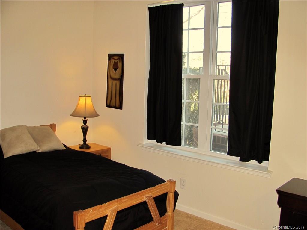 1068 Drayton Court, Unit 100 Fort Mill, SC 29708 - Photo 13 of 15 a blue bed sitting in a bedroom next to a window