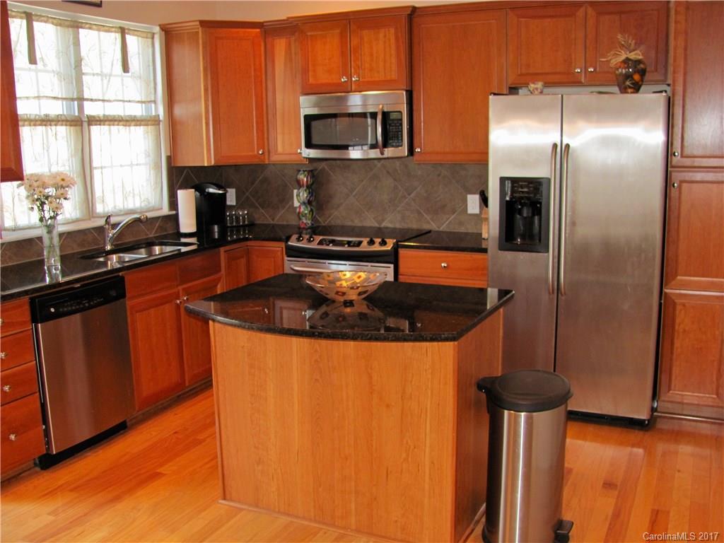 1068 Drayton Court, Unit 100 Fort Mill, SC 29708 - Photo 3 of 15 a kitchen with stainless steel appliances granite countertop a sink a stove and a refrigerator