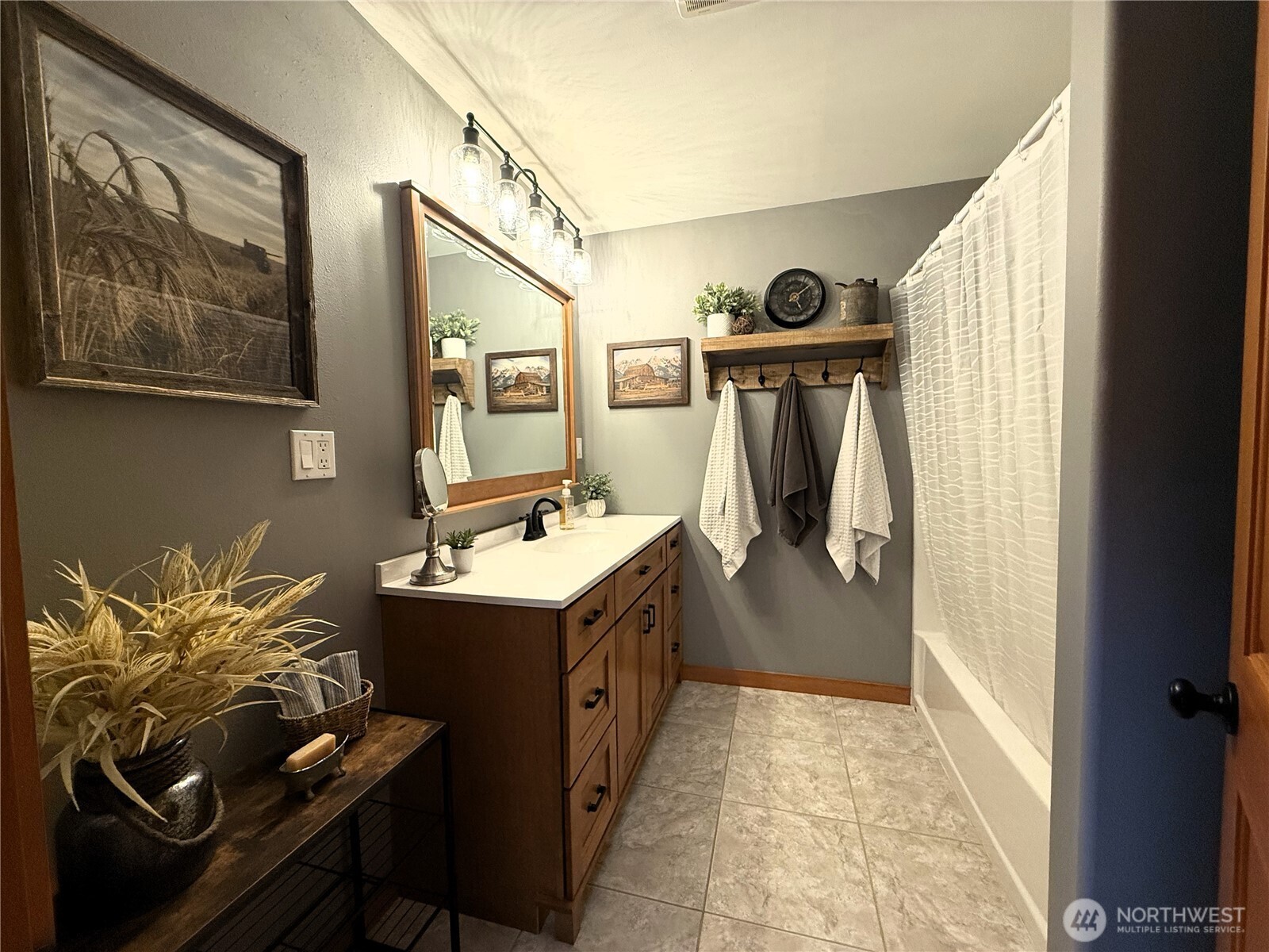 8 Julian Bay Road Republic, WA 99166 - Photo 11 of 40 a bathroom with a sink a mirror and painting on the wall